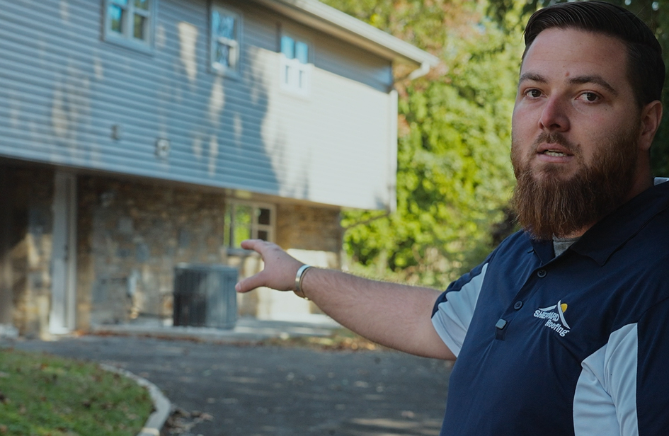 Jake Duncan of Sheppard Exteriors explaining the exterior renovation at a Yew Road home in Cheltenham Pennsylvania